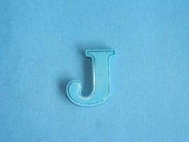 Macro photo or closeup photo of the alphabet from children's toys on a blue background. Use on preschool also