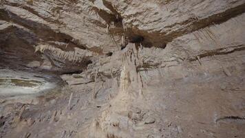 Formations in caves. Action. Beautiful walls of lighted cave with formations. Stalactites and stalagmites in cave halls video