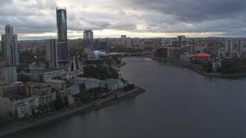 Grey city.Stock footage.Drone view of a big city with various beautiful buildings and a long dirty river and visible gray clouds over the city. video