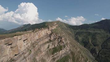 Beautiful green mountains. Action. Landscape of large summer mountains over which there is a light blue sky. video