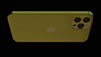 Abstract spinning yellow new Apple smartphone isolated on a black background. Design. Iphone device rotating in the dark, seamless loop. For editorial use only. video