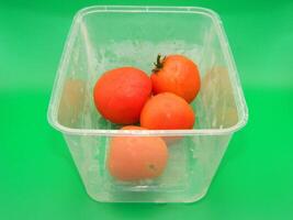 Macro photo of food ingredients in the form of vegetables. It is in a box-shaped container with a green background