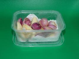 Macro photo of food ingredients in the form of vegetables. It is in a box-shaped container with a green background