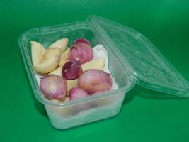 Macro photo of food ingredients in the form of vegetables. It is in a box-shaped container with a green background