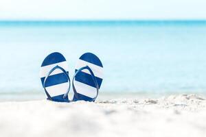Flip flops on the sandy beach photo