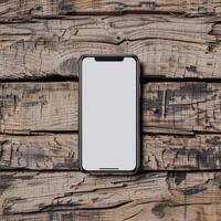 Smartphone mockup with a blank screen on a rustic wooden table background photo