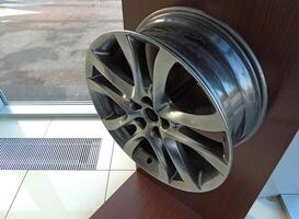 Graphyte Color Painted Alloy Wheel Disk On A Shelf In Dealership photo