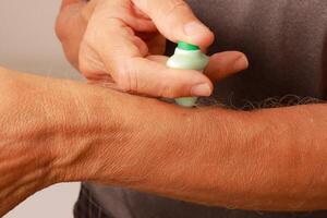 Man using a Pocket Zapper for mosquito bites and other bug bites to help stop the itching photo