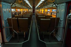 Public trains in Java, Indonesia are empty of passengers in the afternoon when the sun sets. The train carriage was quiet and many passenger seats were empty photo