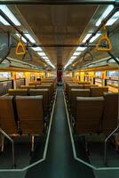 Public trains in Java, Indonesia are empty of passengers in the afternoon when the sun sets. The train carriage was quiet and many passenger seats were empty photo