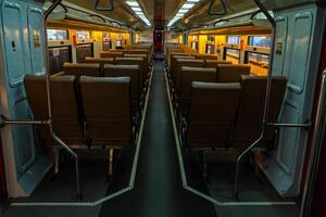 Public trains in Java, Indonesia are empty of passengers in the afternoon when the sun sets. The train carriage was quiet and many passenger seats were empty photo