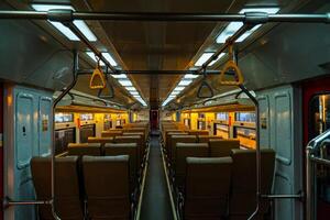 Public trains in Java, Indonesia are empty of passengers in the afternoon when the sun sets. The train carriage was quiet and many passenger seats were empty photo