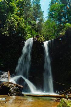 This unspoiled seasonal waterfall in the middle of the wilderness is called the Grenjengan Kembar waterfall. Detailed photos of the waterfall using a slow shutter speed technique
