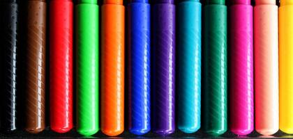 Pen Caps Of Colorful Felt Pens In A Row Closeup Texture Background photo