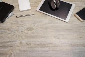 Copyspace of smart phone tablet and computer devices with wood background photo
