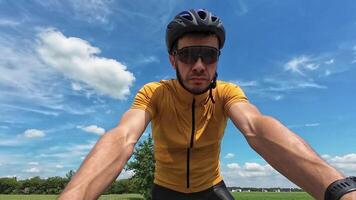 Man rides his bike on sunny day. Cyclist training on bicycle video