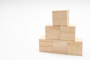 Cube shape wooden block toy stacked in pyramid shape without graphics for Business design concept. blank wooden cubes. photo