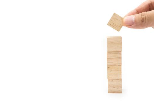 Hand putting blank wooden cube block isolated on white background. Empty wooden blocks for text. Copy space. photo