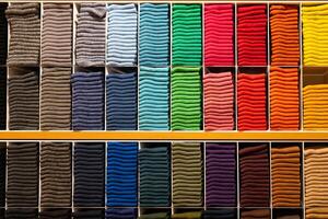 Multi color socks stacked for display at the store. colorful socks selective focus photo