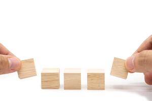 Hand place 5 Blank wooden cube blocks for text isolated on white background. 5 Empty wooden blocks. Copy space. Blank space for input wording and infographic icon. photo