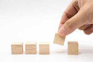 Hand place 5 Blank wooden cube blocks for text isolated on white background. 5 Empty wooden blocks. Copy space. Blank space for input wording and infographic icon. photo