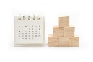 Cube shape wooden block toy stacked in pyramid shape without graphics for Business design concept and calendar. blank wooden cubes. photo