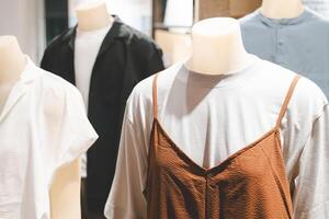 mannequin dressed in casual clothes. shelf display in shop mall store. Store Of Shopping Center. photo