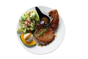 Pork Chop Steak is a pork steak that uses thigh meat or bone-in sirloin. Pork chops are soft, juicy, and have a little bit of fat. Eat with salad, mashed potatoes, and sauce. photo