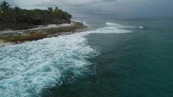 Drone view of ocean with waves and coastline on Fuvahmulah island with cloudy weather video