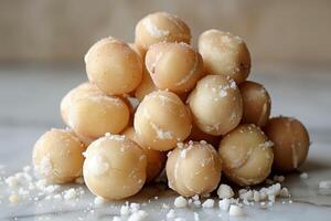 Close-up of salted macadamia nuts on a marble countertop in daylight photo