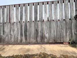 Weathered Wooden Fence with Concrete Base photo