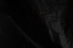 Black crumpled paper with shadow for background. wrinkled surface, design, wallpape photo