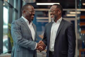 Two professional business men executive leaders shaking hands at office meeting, photo