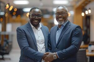 Two professional business men executive leaders shaking hands at office meeting, photo