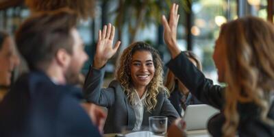 group of colleagues giving a high five in meeting. photo