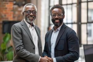 Two professional business men executive leaders shaking hands at office meeting, photo