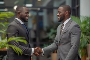 Two professional business men executive leaders shaking hands at office meeting, photo