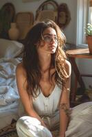 Unhappy woman thinking about problems, sitting in the bed alone looking away. photo
