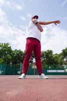 Athletic bearded man warms up before workout at the stadium photo