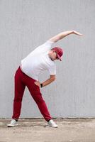 Athletic bearded man warms up before workout at the stadium photo