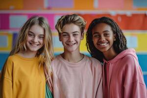 group of three happy teenage students in bright clothes. photo
