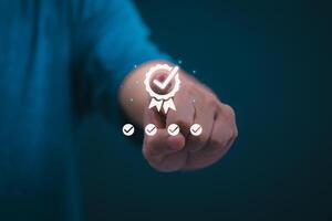 Male hand pointing at symbol of guarantee of quality of service Certification concept and standard quality control Standard warranty Documents certified on virtual screen photo