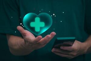 Businessman showing a symbol or icon related to health insurance or healthcare. Concepts for developing and accessing care anywhere, anytime, doing business related to the hospital business photo