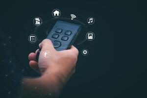 Concepts of using digital media, social media Surfing online, male hand using remote control To play or use social media, the concept of working remotely, working from home via the internet. photo