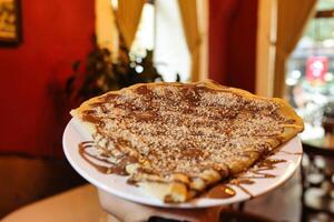 Chocolate Nutella Crepe With Powdered Sugar photo