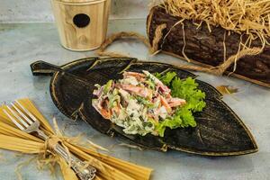 Creamy Salad With Carrots and Lettuce on Leaf-Shaped Plate photo