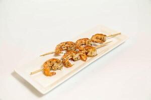 White Plate Topped With Delicious Shrimp Skewers photo