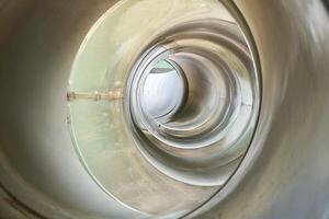 Inside part of gray colored round slide toy tunnel hole isolated on horizontal ratio full frame background. photo
