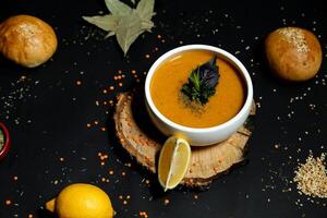 Delicious Carrot Soup With a Refreshing Lemon Slice photo