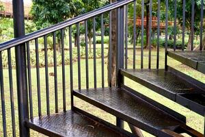Black metal iron stair case walk way with hand railing isolated on horizontal ratio outdoor park environment background. photo